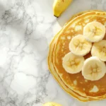 Top-down view of Kylie Jenner's banana pancakes on a marble surface.