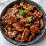 Savory black pepper beef stir-fry on a marble countertop.